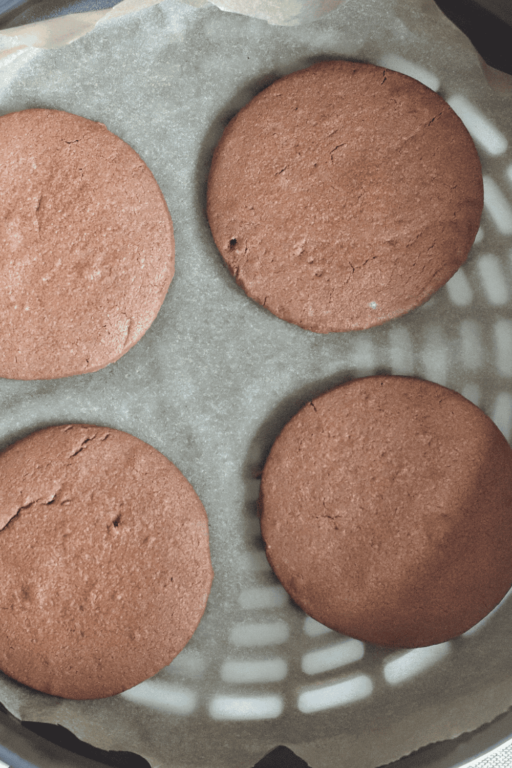 Air Fryer Dark Chocolate Peppermint Cookies on a cooling rack, topped with crushed candy canes