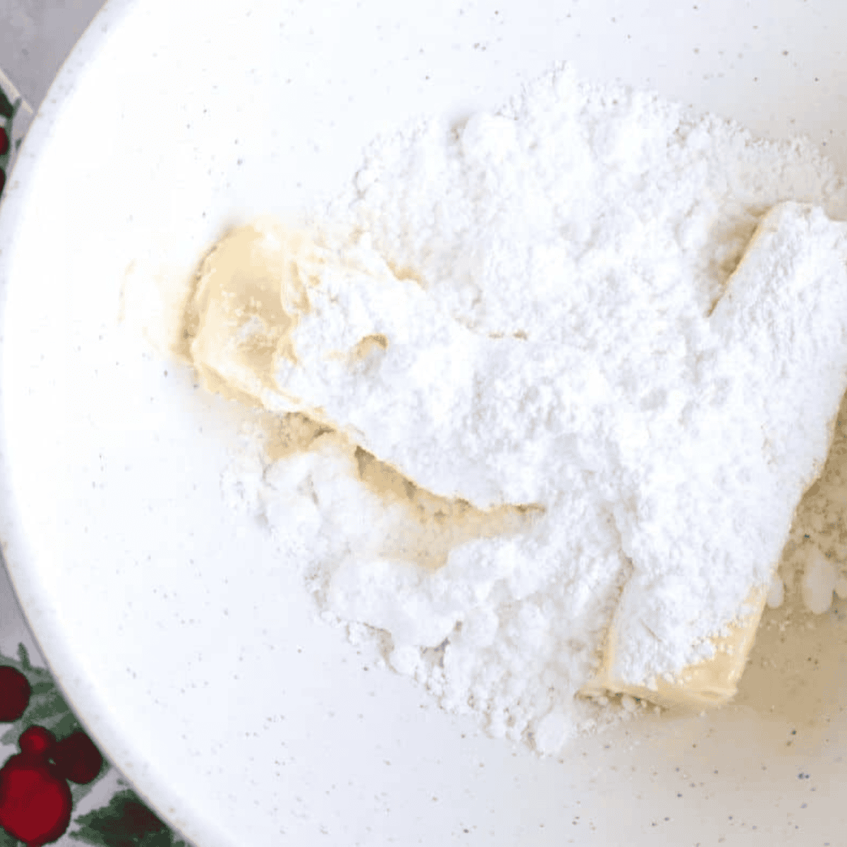 Mixing egg yolks with butter and sugar in bowl