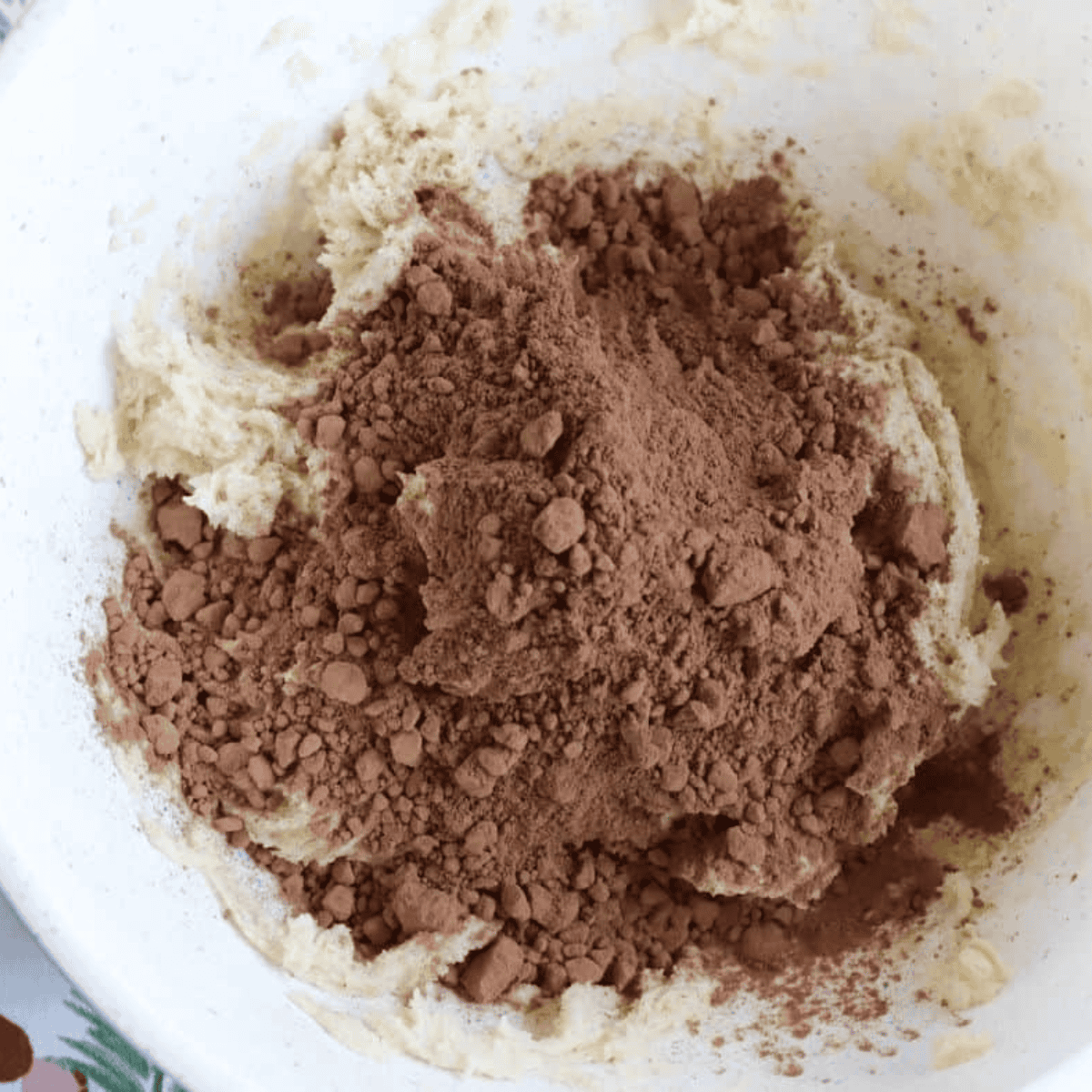 Mixing flour, cocoa powder, and salt before adding to batter