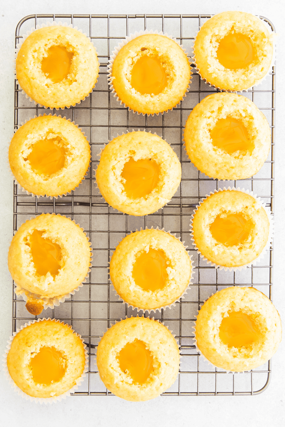 Freshly baked cupcakes cooling on a wire rack, ready to frost and decorate.
