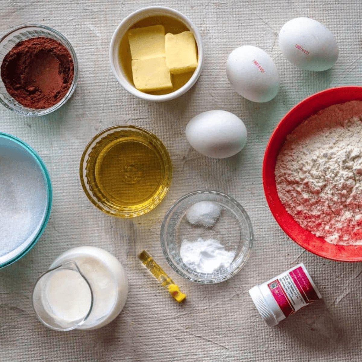 Ingredients needed for Air Fryer Red Velvet Cupcakes on kitchen table.