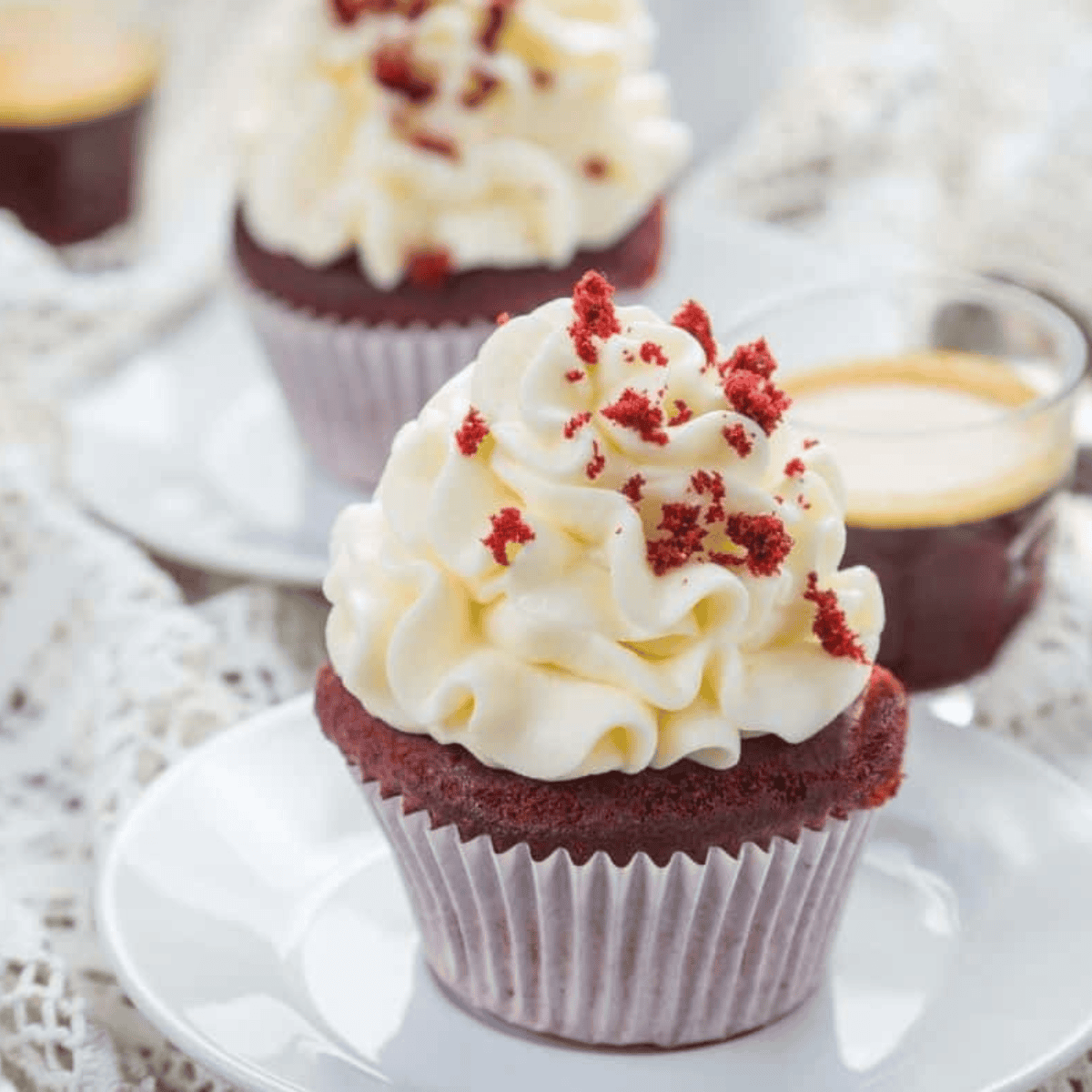 Freshly baked Air Fryer Red Velvet Cupcakes with smooth cream cheese frosting and bright red interior.