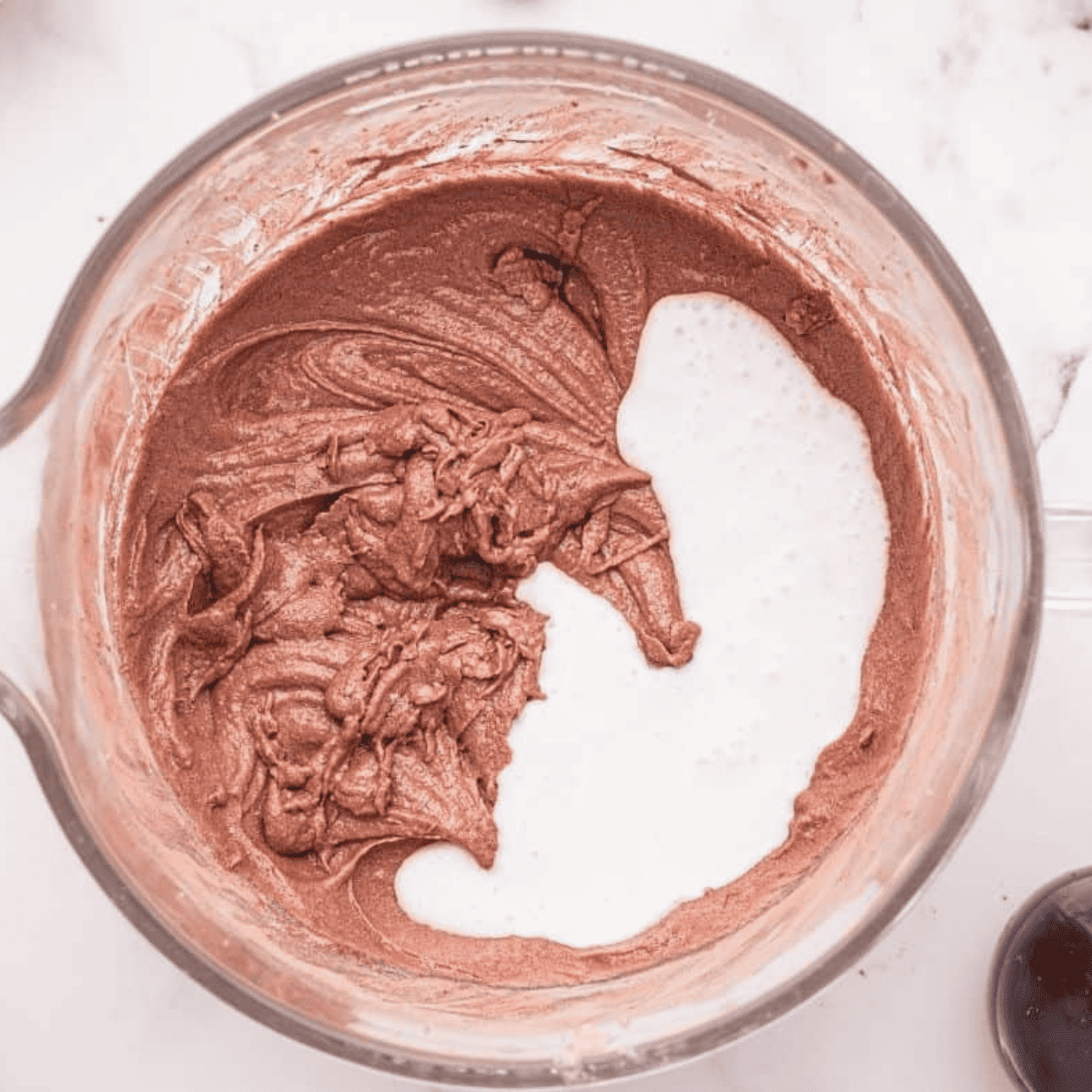 Mixing unsweetened cocoa powder, baking soda, and boiling water in a large bowl until smooth, then cooling to room temperature.