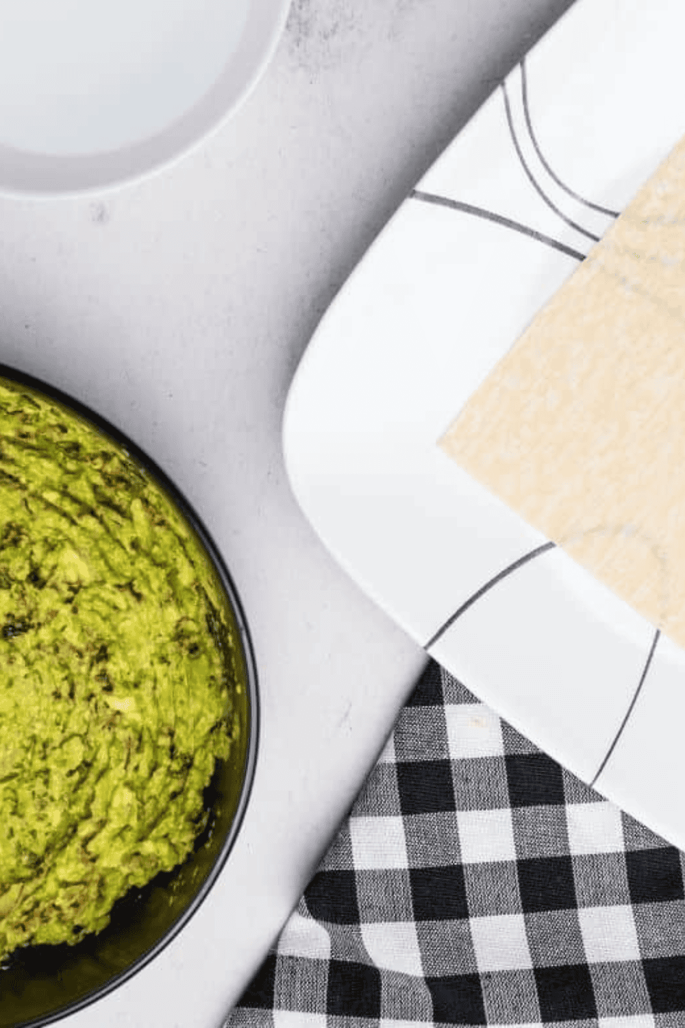 Filling being placed on egg roll wrapper and rolled tightly for sealing