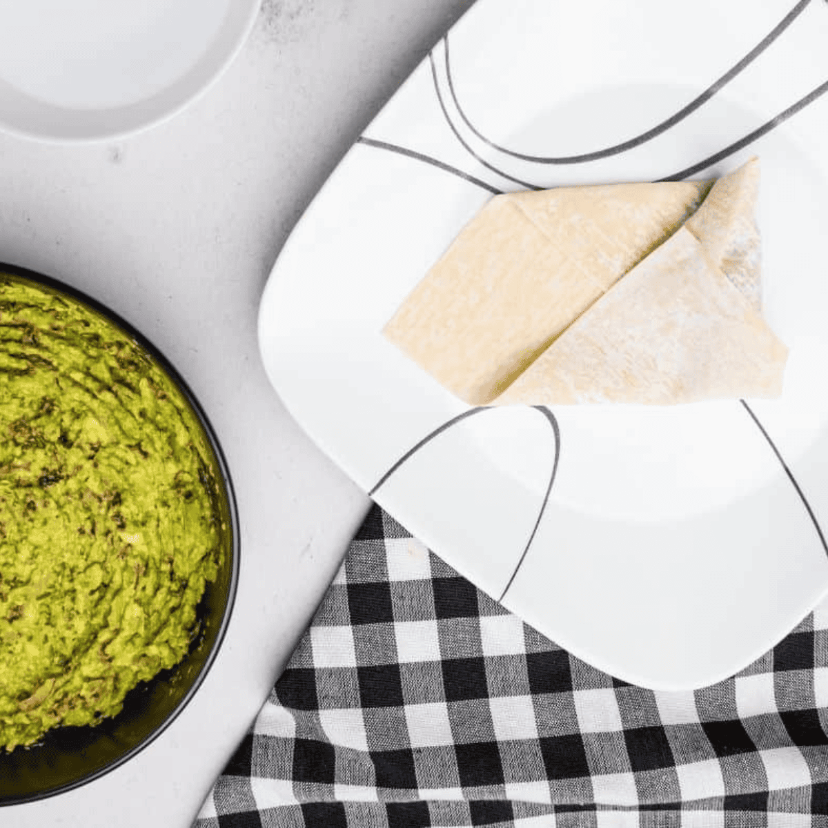 Egg rolls lightly brushed with oil on a tray before cooking