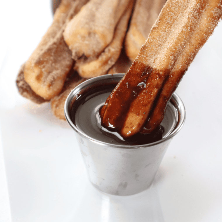 Homemade churros cooking in air fryer basket until golden brown