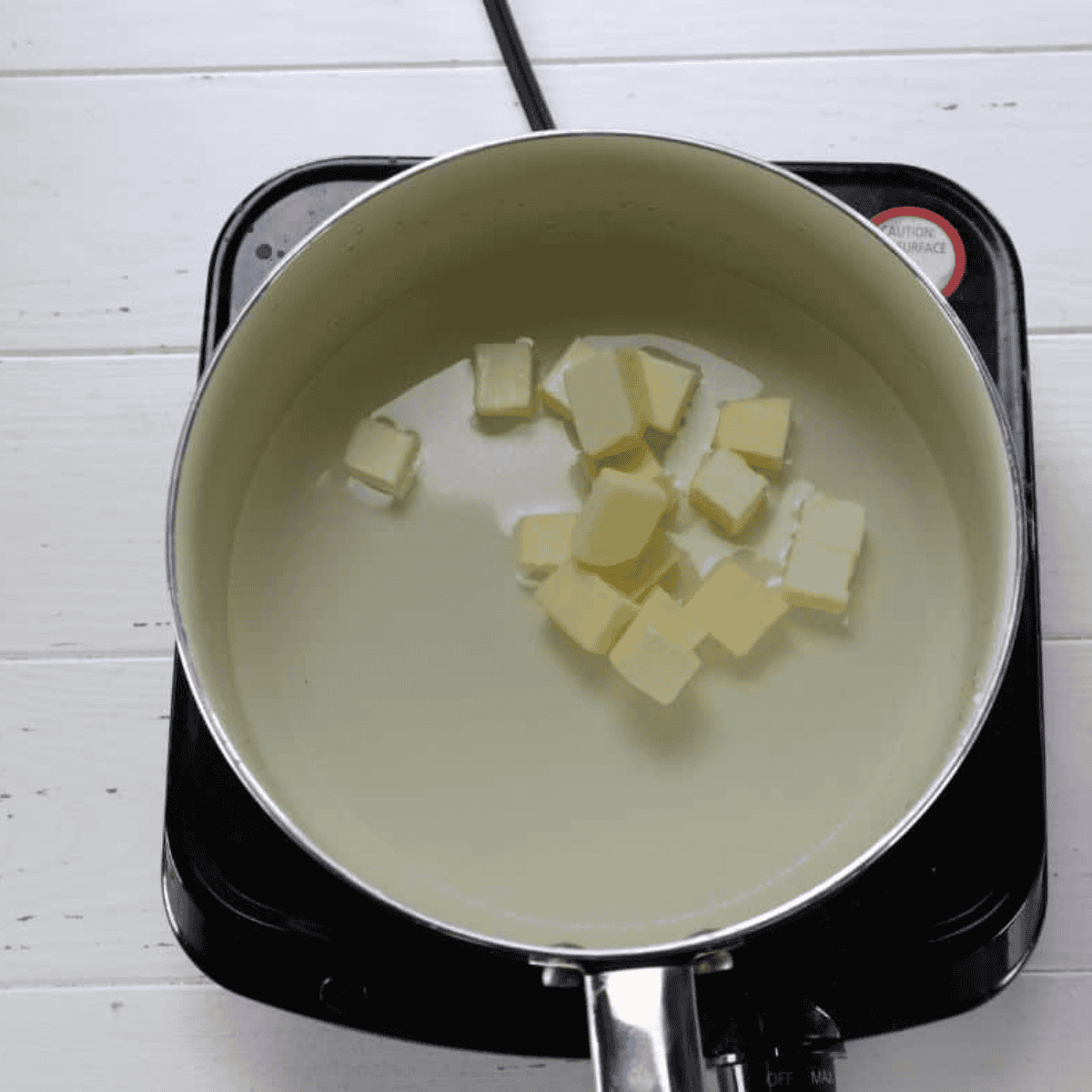 Melting the butter into the saucepan.