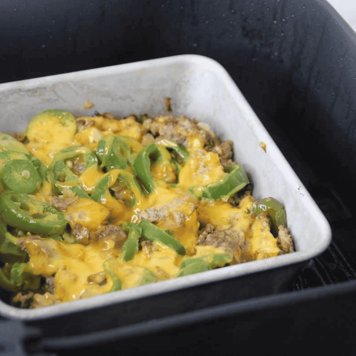 Ingredients mixed well with the chopped beef, with melted cheese on top.