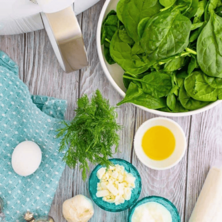 Ingredients needed for Easy Air Fryer Spanakopita Recipe (Greek Spinach Pie) on kitchen table.