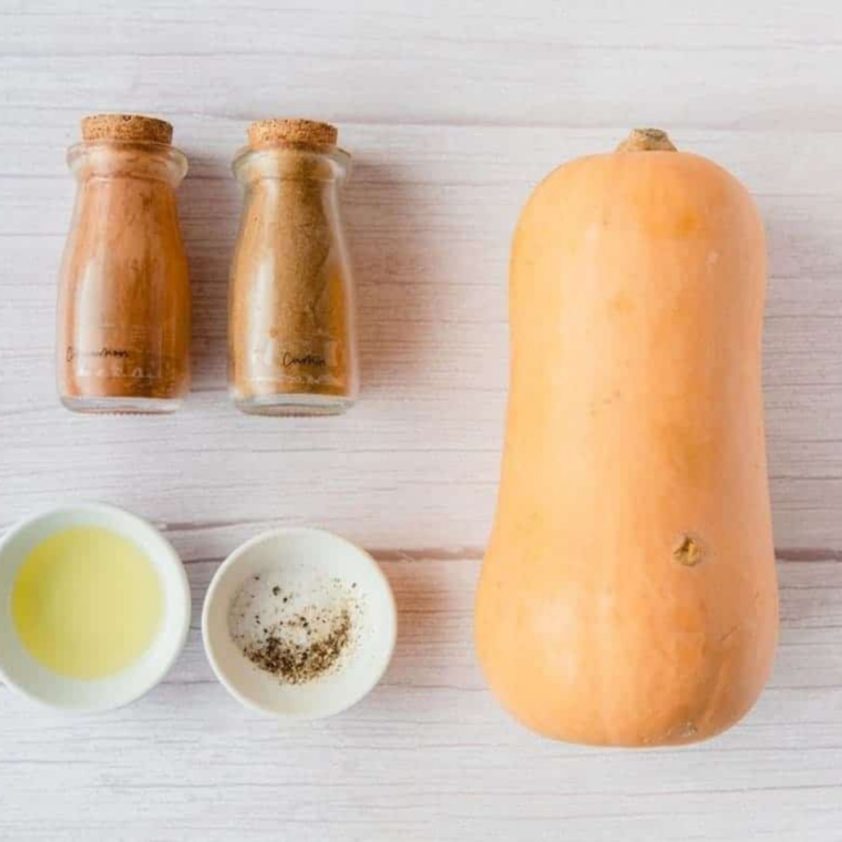 Ingredients for air fryer butternut squash noodles: spiralized squash, olive oil, salt, pepper, and garlic powder