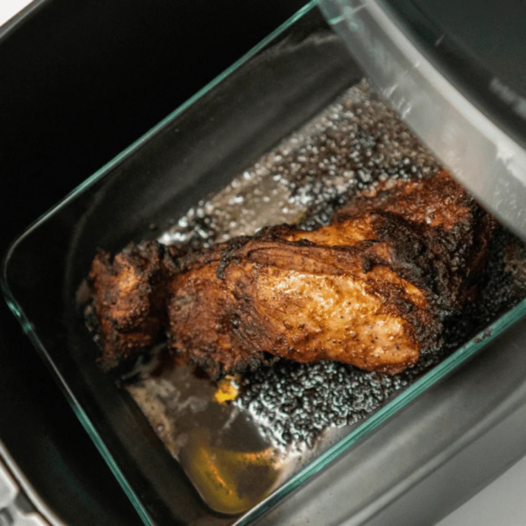 Air fryer pork carnitas with deeply browned crispy edges after cooking at 400°F