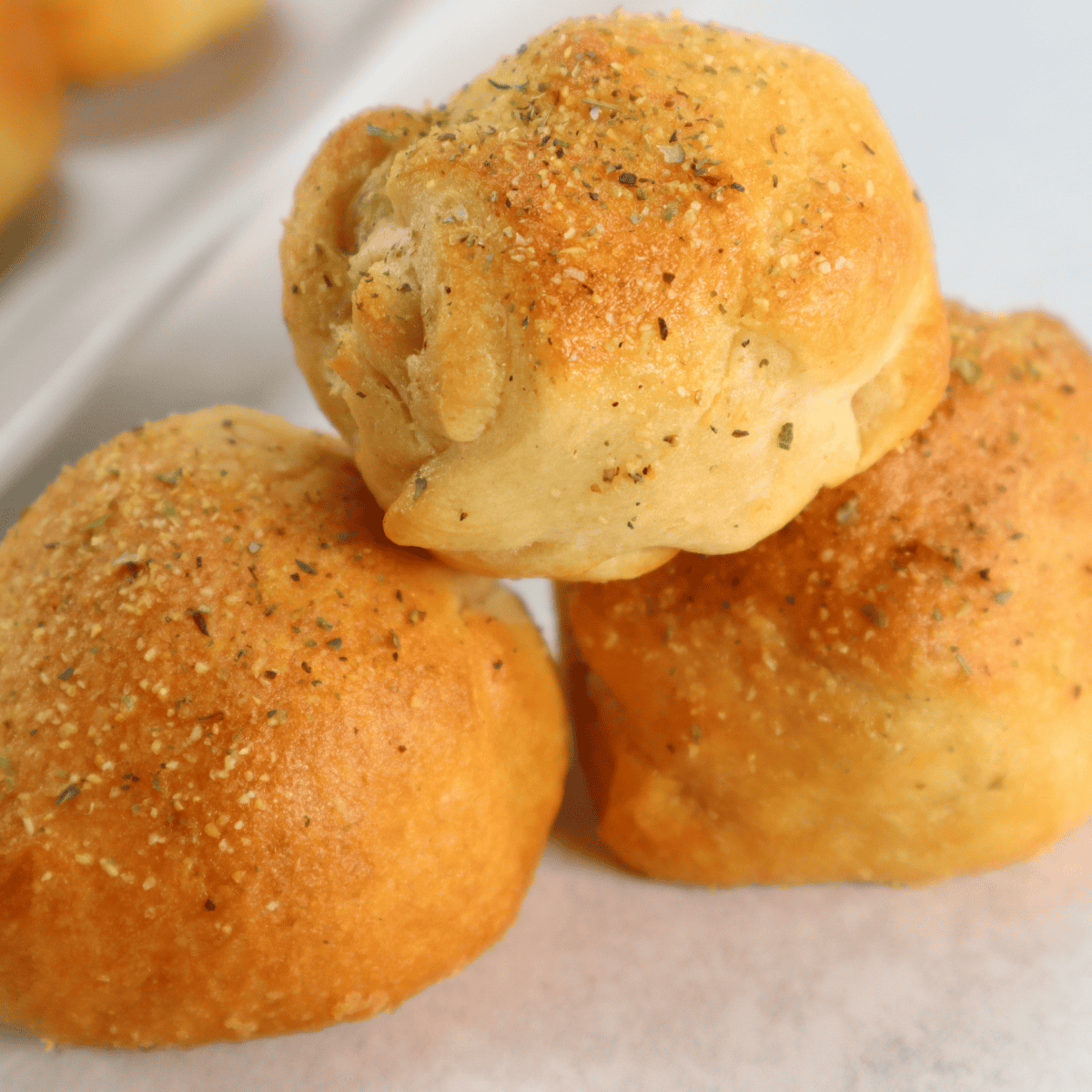 Golden air fryer bacon-wrapped cheese bombs with melty cheese inside