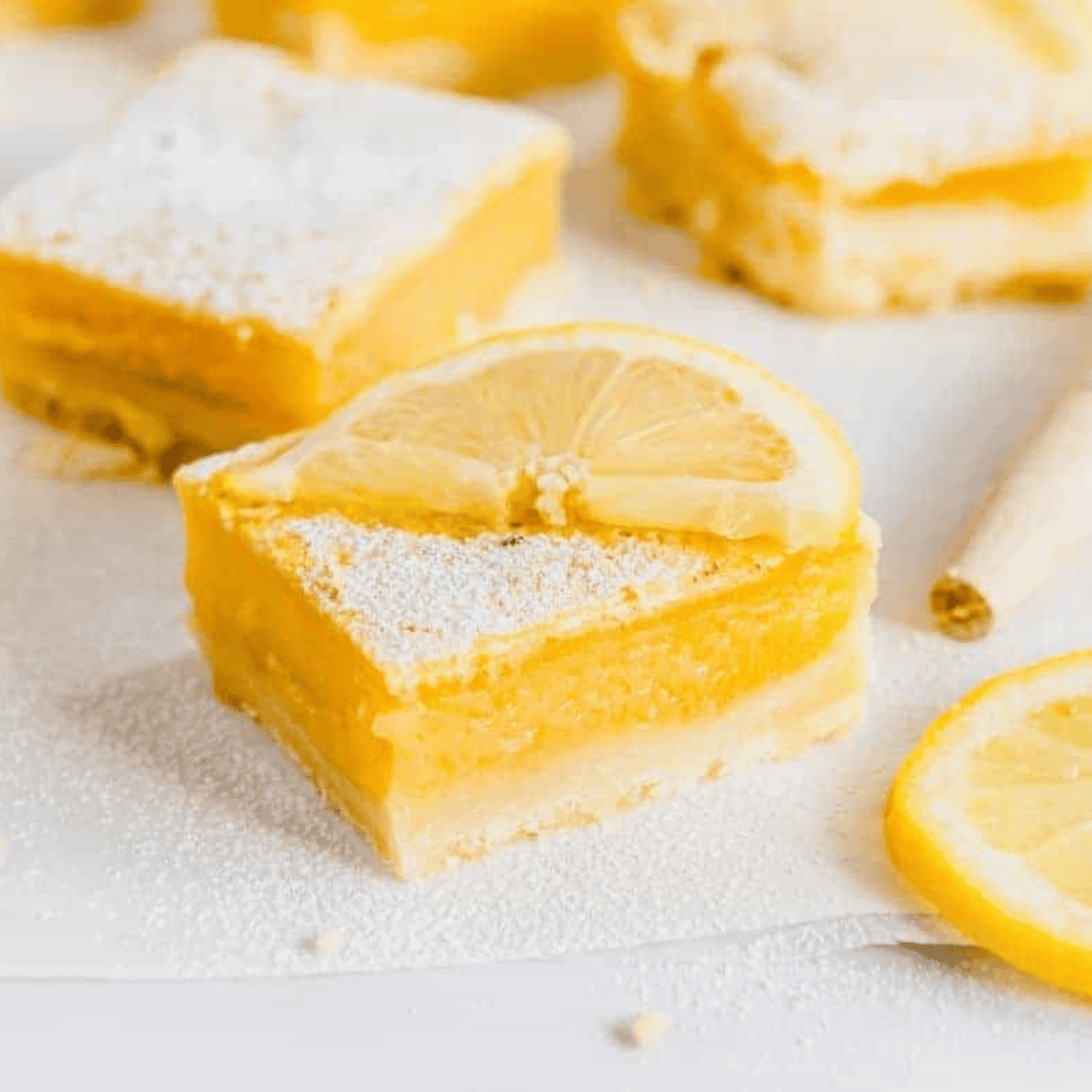 Air fryer lemon bars with golden shortbread crust and tangy lemon filling, dusted with powdered sugar and ready to serve.