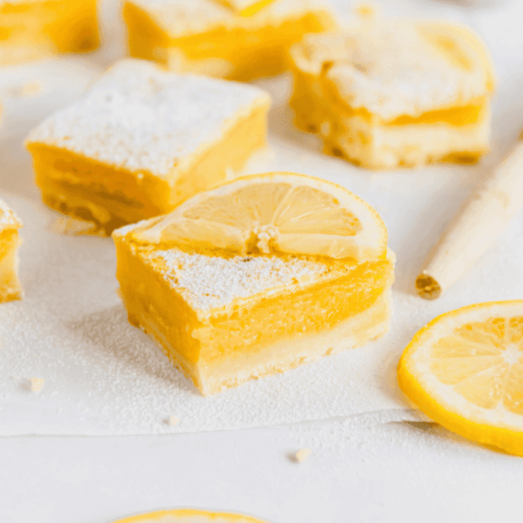 Air fryer lemon bars with golden crust and smooth, tangy lemon filling, dusted with powdered sugar.
