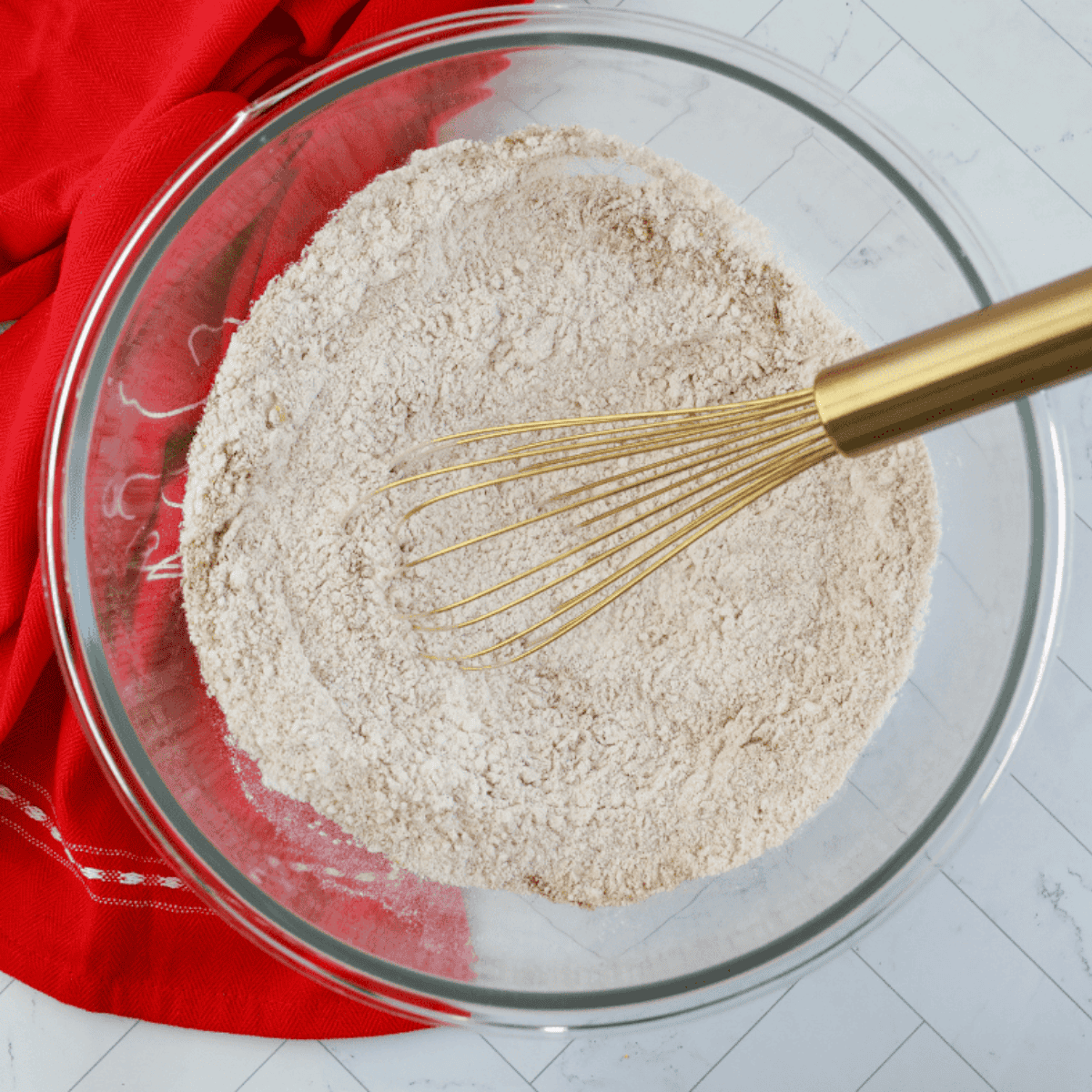 Mixing donut batter ingredients in bowls after spraying donut pan with baking spray