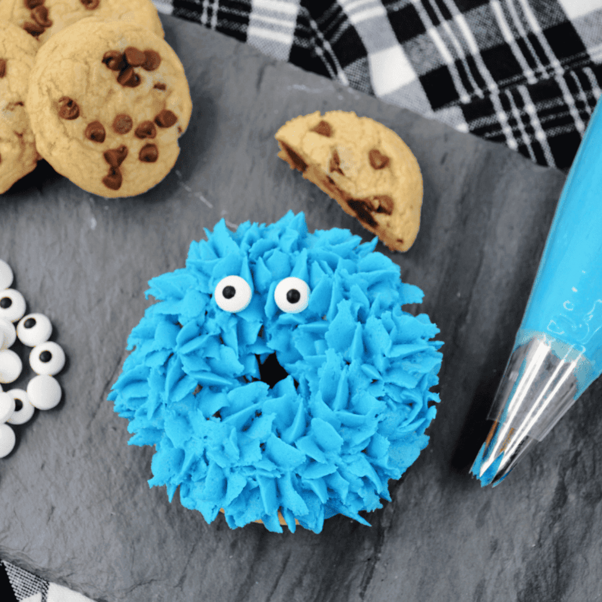 Blue Cookie Monster donuts topped with frosting, cookie pieces, and edible eyes