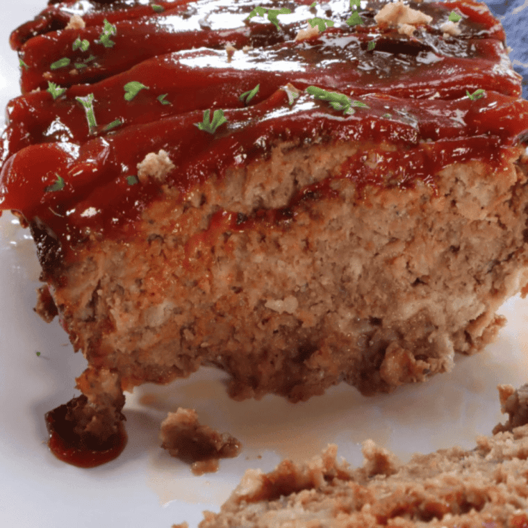 Sliced meatloaf with hickory ketchup sauce on top of each piece