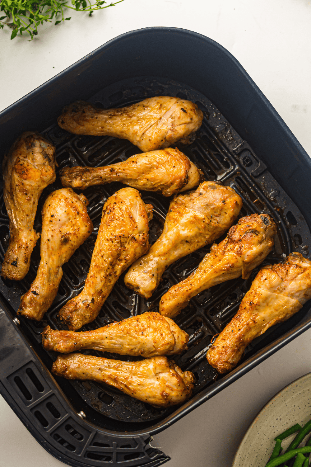 Cooked Easy Air Fryer Garlic Parmesan Chicken Legs in the air fryer basket.