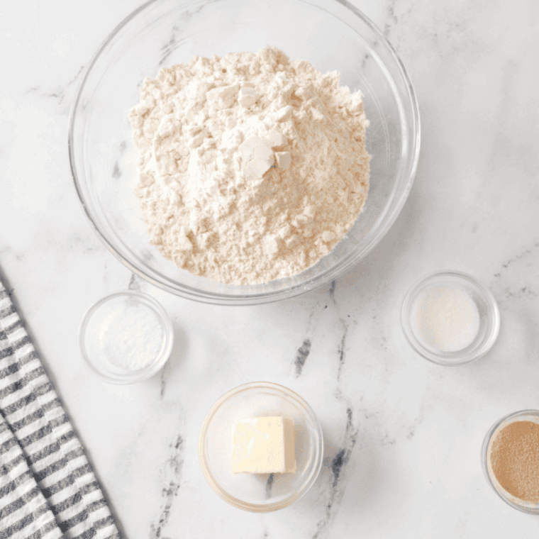 Ingredients needed for Easy Farmhouse White Sandwich Bread on kitchen table.