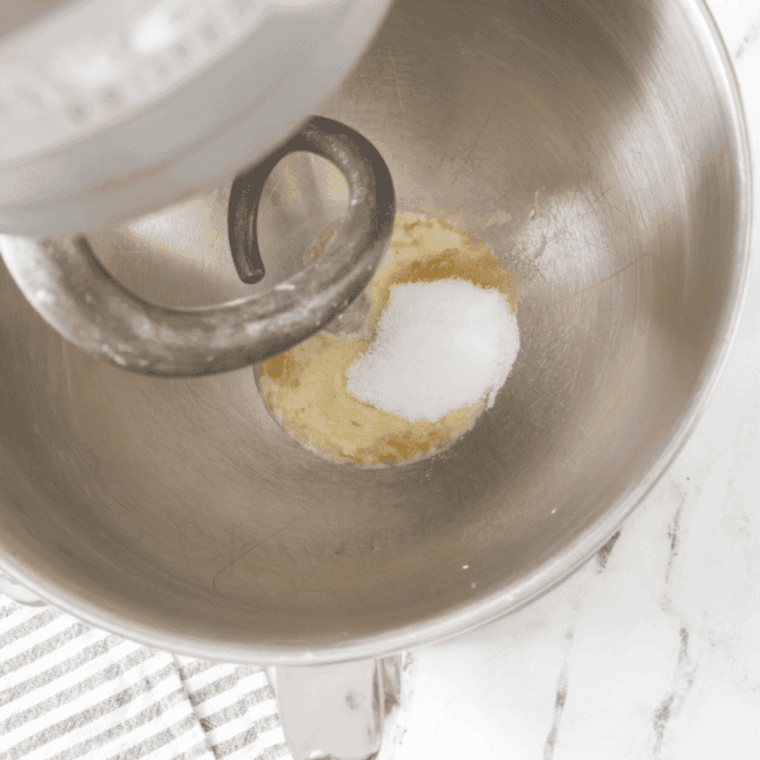 yeast sprinkled over warm water and sugar dissolving in large bowl, frothing