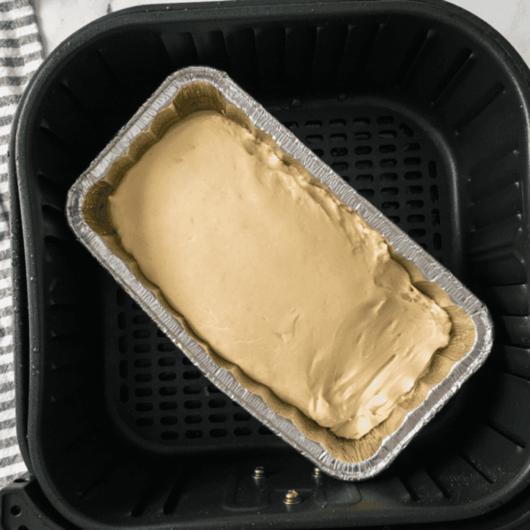dough placed in air fryer basket, baking until golden brown and hollow sounding