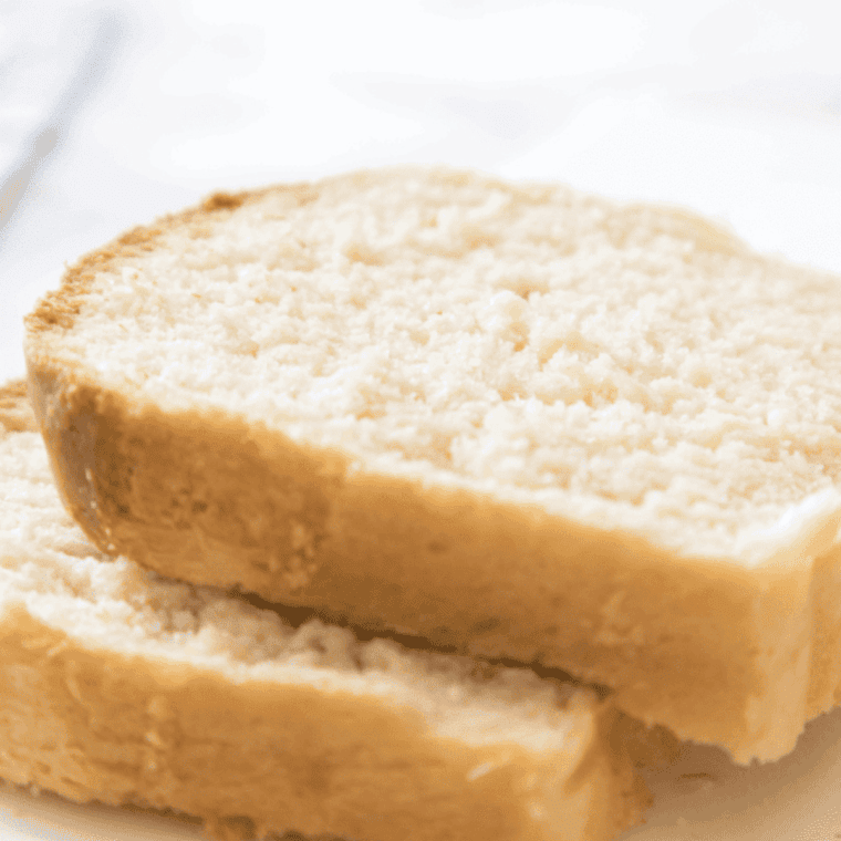 freshly baked golden brown farmhouse white sandwich bread on cutting board