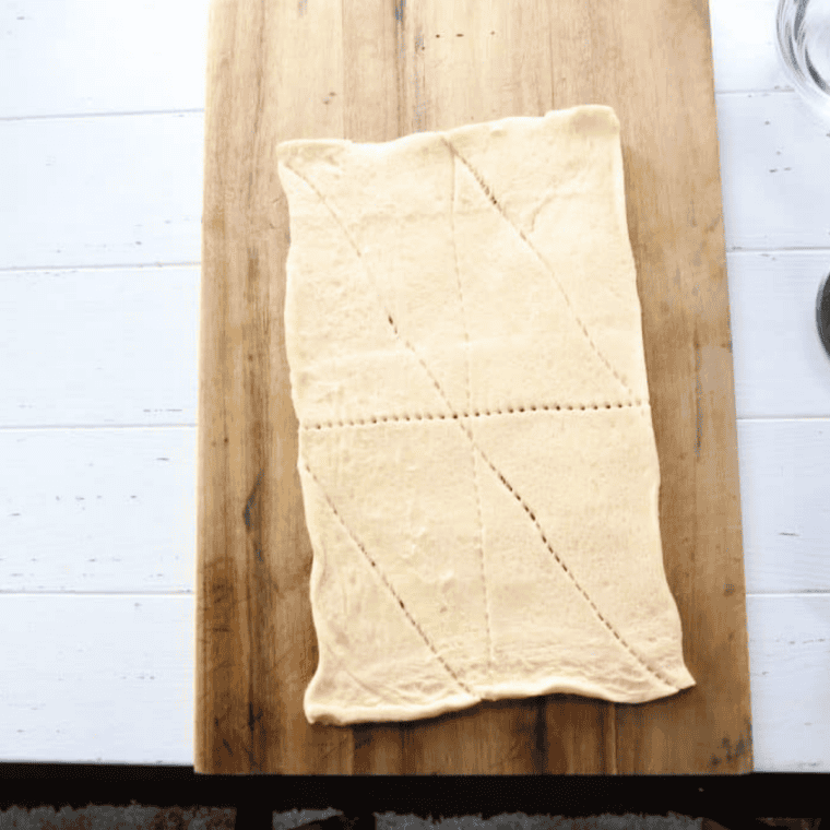 Roll out the dough — Crescent dough unrolled and pressed into an even rectangle on a clean surface