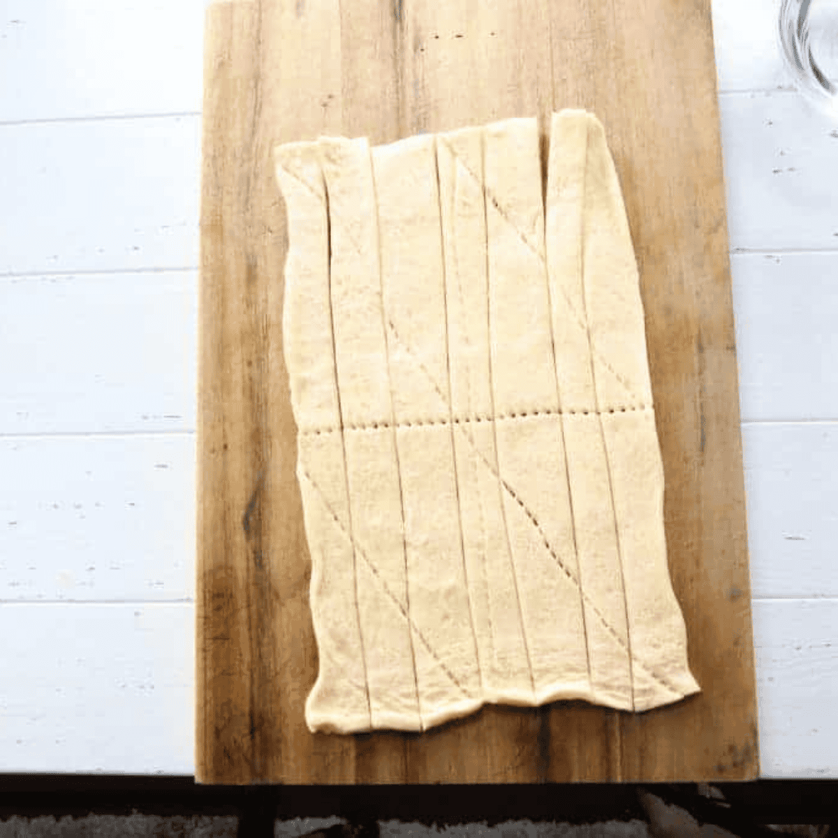 Slice into strips — Crescent dough sliced lengthwise into one-inch strips with a pizza cutter