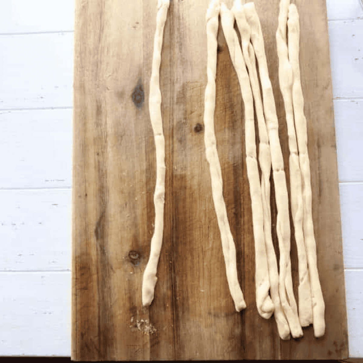 Roll into ropes — Dough strips rolled into thin half-inch ropes for air fryer pretzel bites