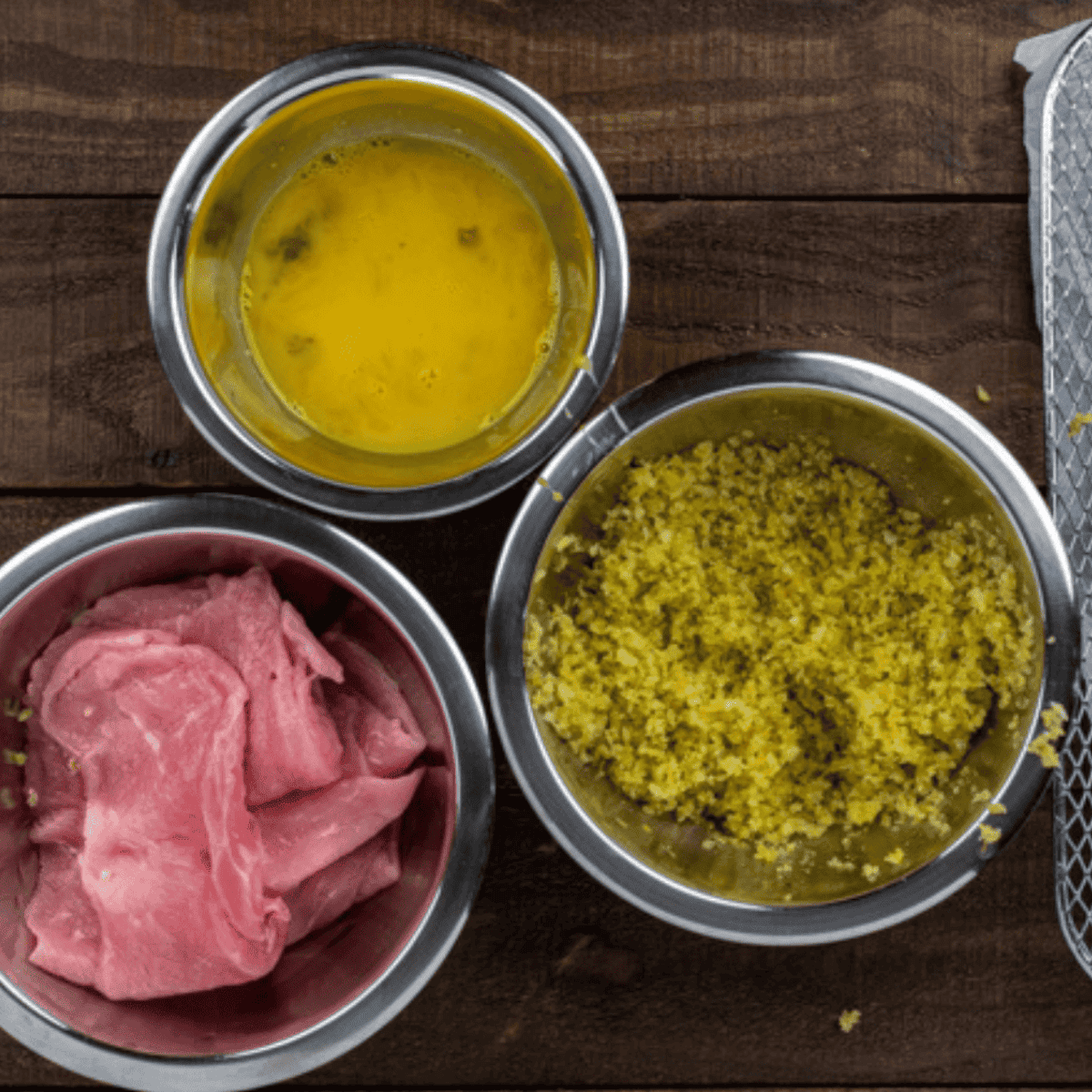 Preparing thin veal cutlets by seasoning them with salt and pepper before air frying.