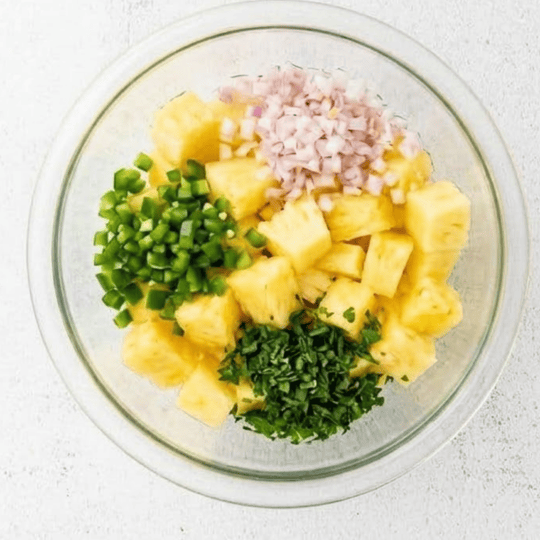 All prepped salsa ingredients placed together in medium mixing bowl