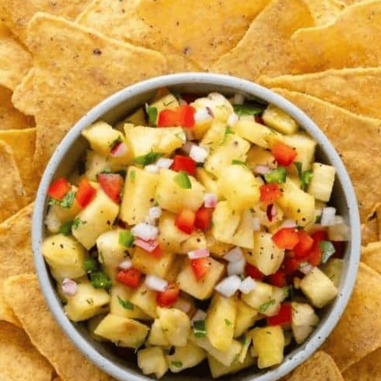 Fresh pineapple salsa with red onion, jalapeño, cilantro, and lime in a bowl, ready to serve.