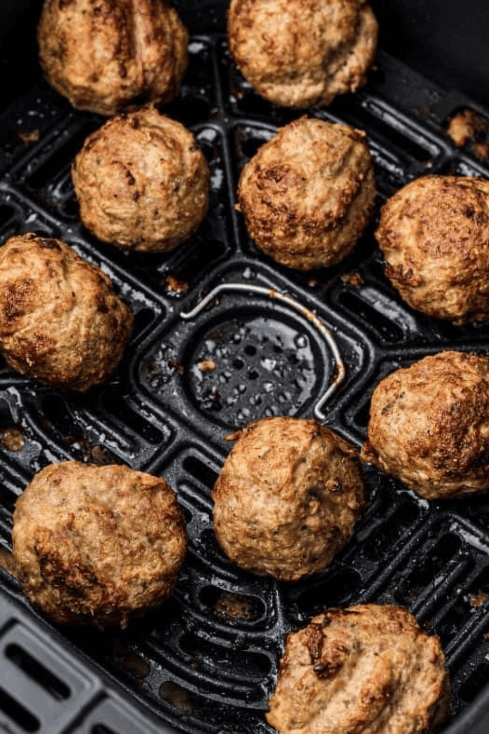 Spicy turkey meatballs garnished with fresh parsley, served on a plate.