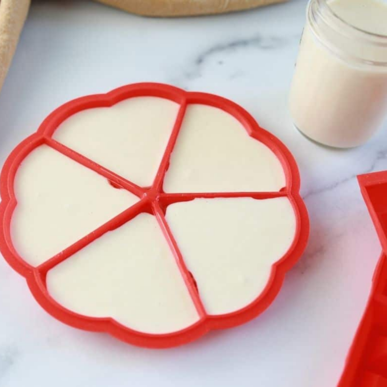Waffle mold sprayed with non-stick spray and set on a baking sheet, ready to be filled.