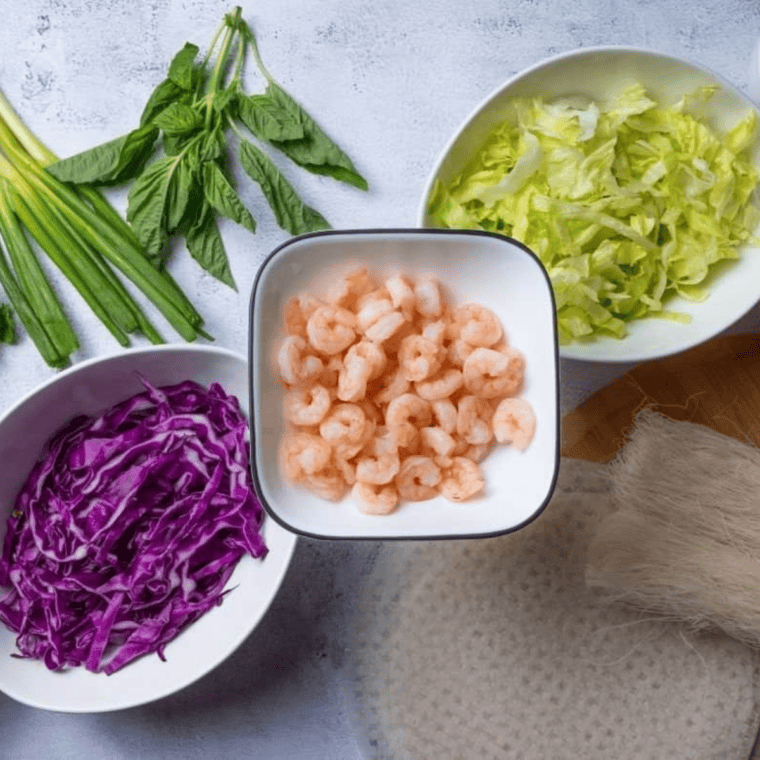 Ingredients needed for Easy Crispy Air Fryer Rice Paper Rolls With Prawns on kitchen table.