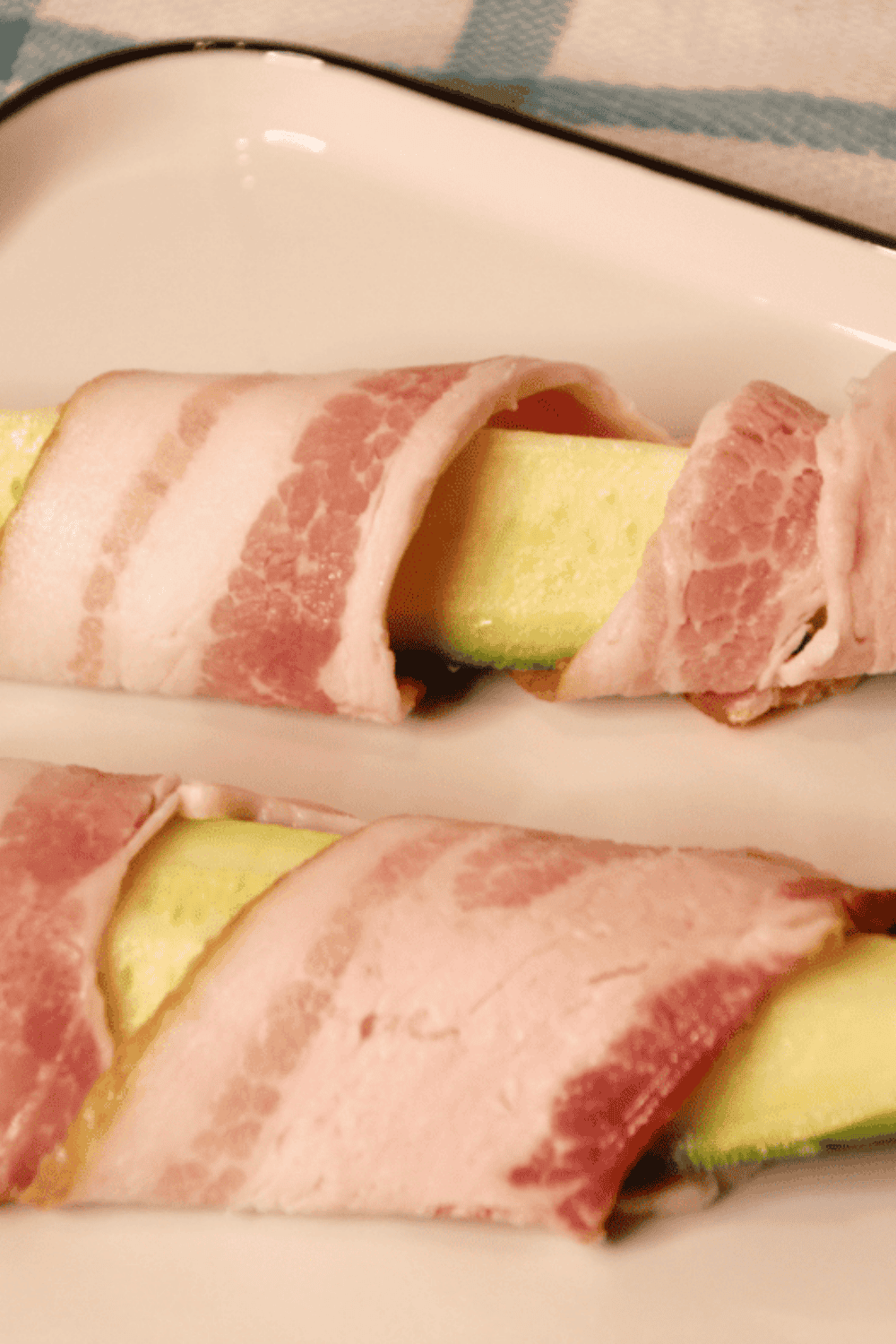Zucchini wedges coated in olive oil and seasoned with garlic, onion, salt, and black pepper.