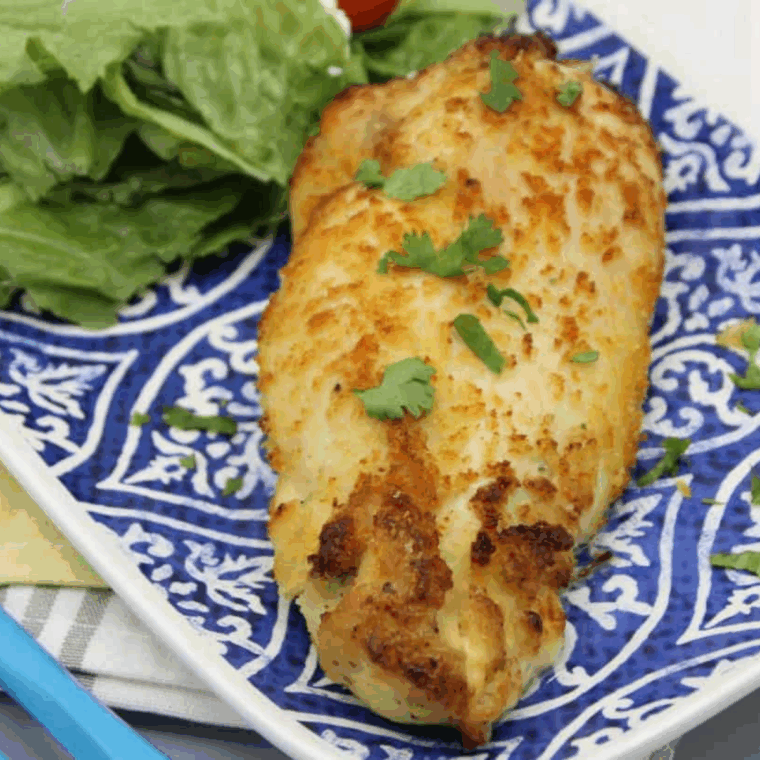 Air Fryer Feta and Spinach Stuffed Chicken Breasts, golden and crispy, served on a plate with garnish.