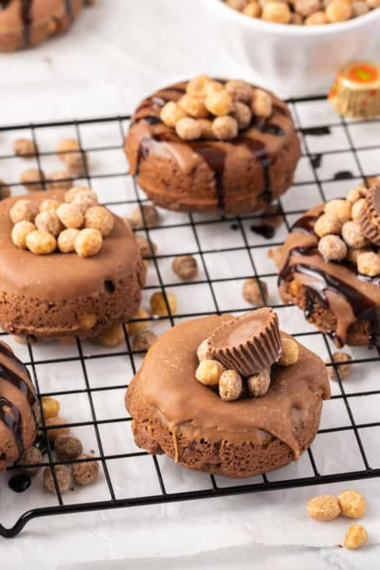 Freshly baked chocolate donuts cooling on a wire rack after air frying