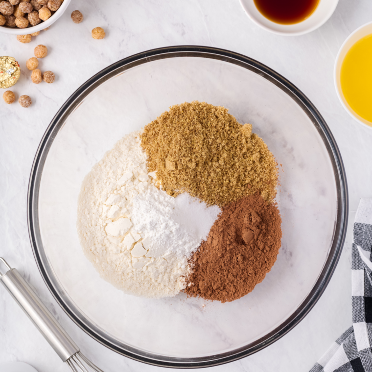Flour, cocoa powder, crushed Reese's Puffs cereal, baking powder, and salt whisked together in a glass mixing bowl