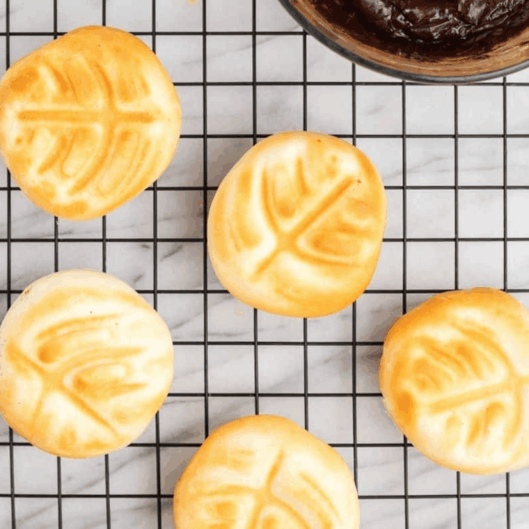 Filling donut from the side using a piping bag for extra Bavarian cream