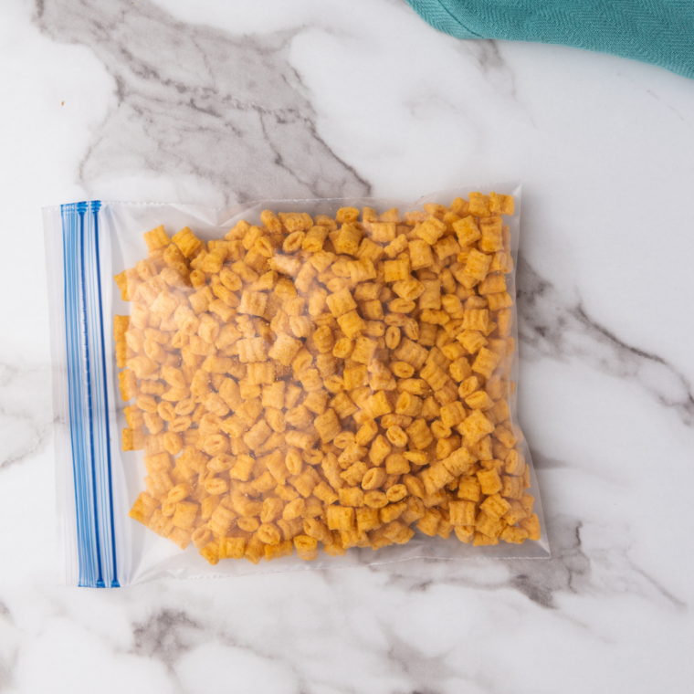 Prepare the Coating: Crushed Cap&rsquo;n Crunch cereal mixed with cinnamon and sugar in a shallow bowl..