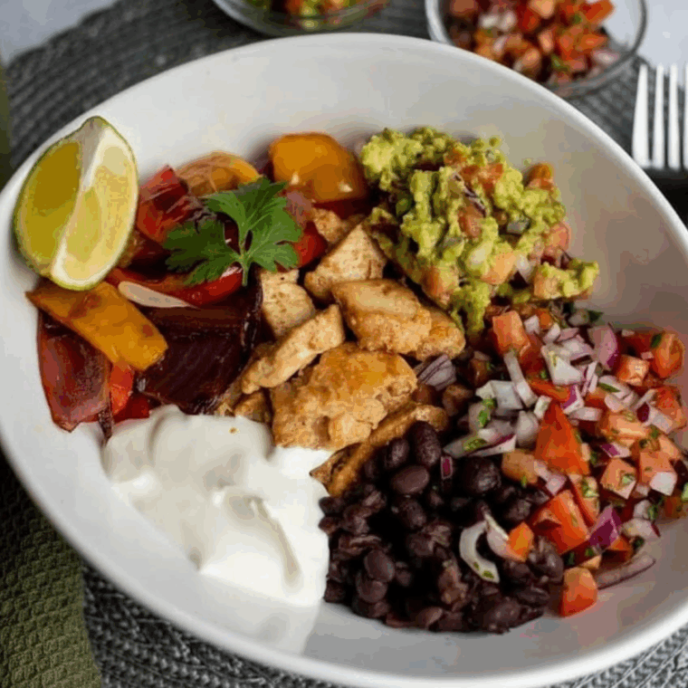 Air Fryer Chicken Fajita Rice Bowl with seasoned chicken, bell peppers, onions, and rice in a bowl