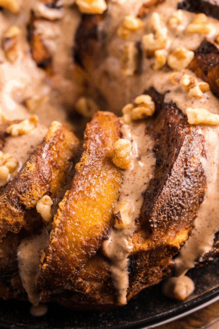 Golden, pull-apart cinnamon roll monkey bread fresh from the air fryer, drizzled with cream cheese frosting