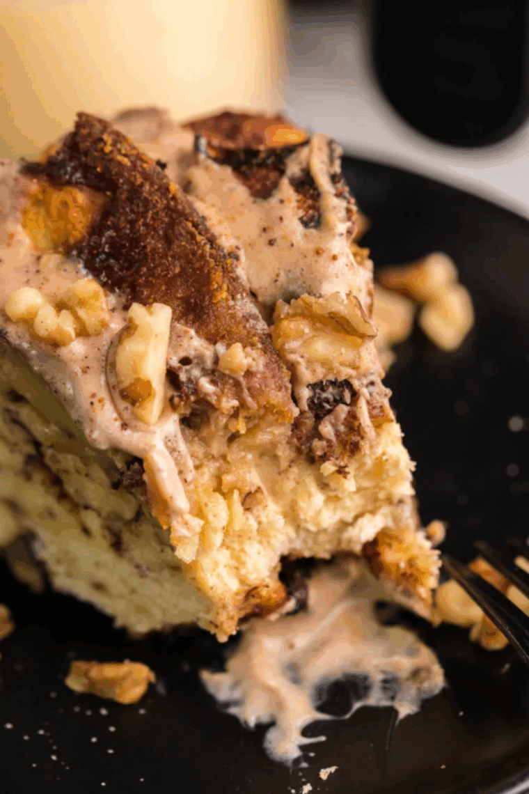 Golden, pull-apart cinnamon roll monkey bread fresh from the air fryer, topped with cream cheese frosting