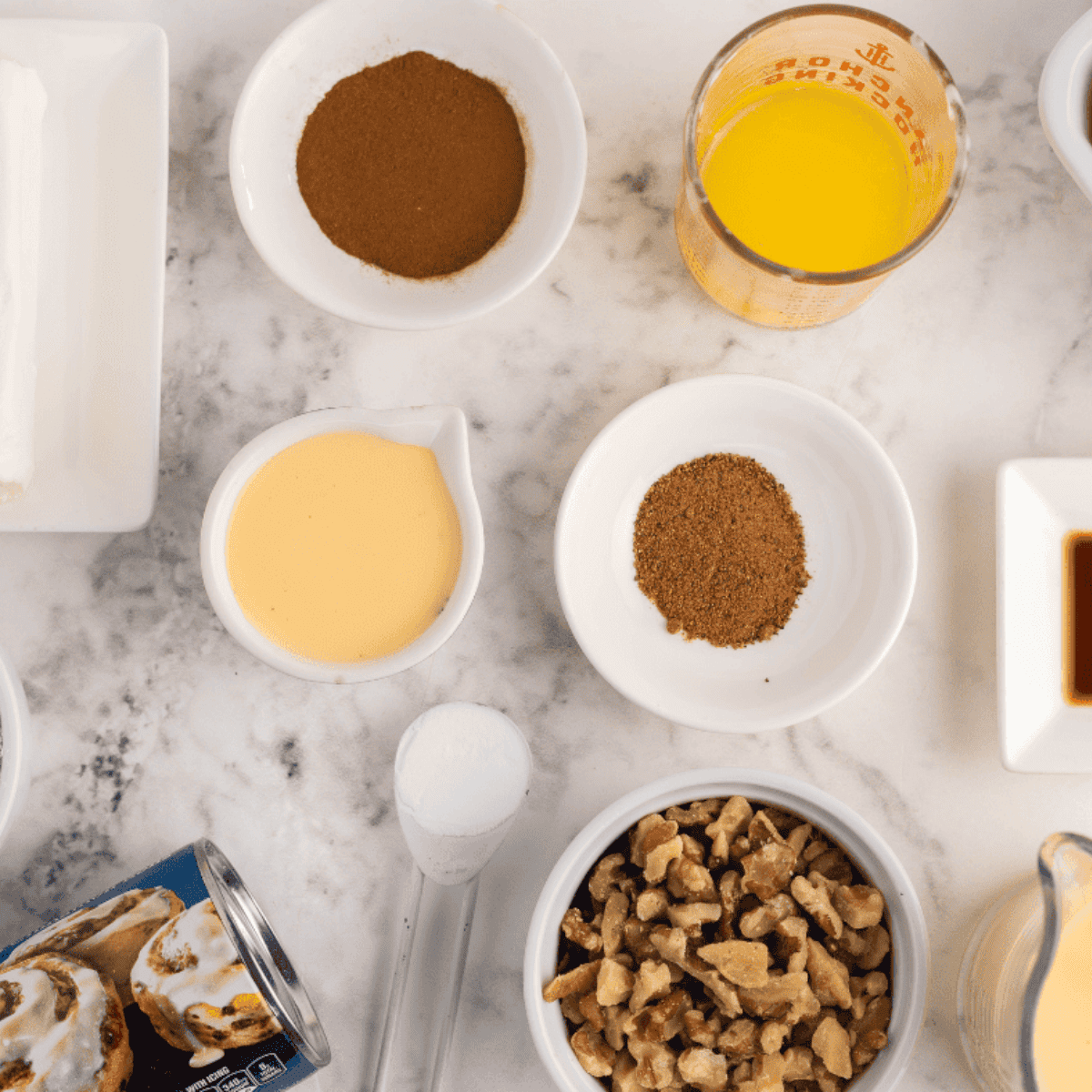 Ingredients needed for Air Fryer Cinnamon Roll Monkey Bread on kitchen table.