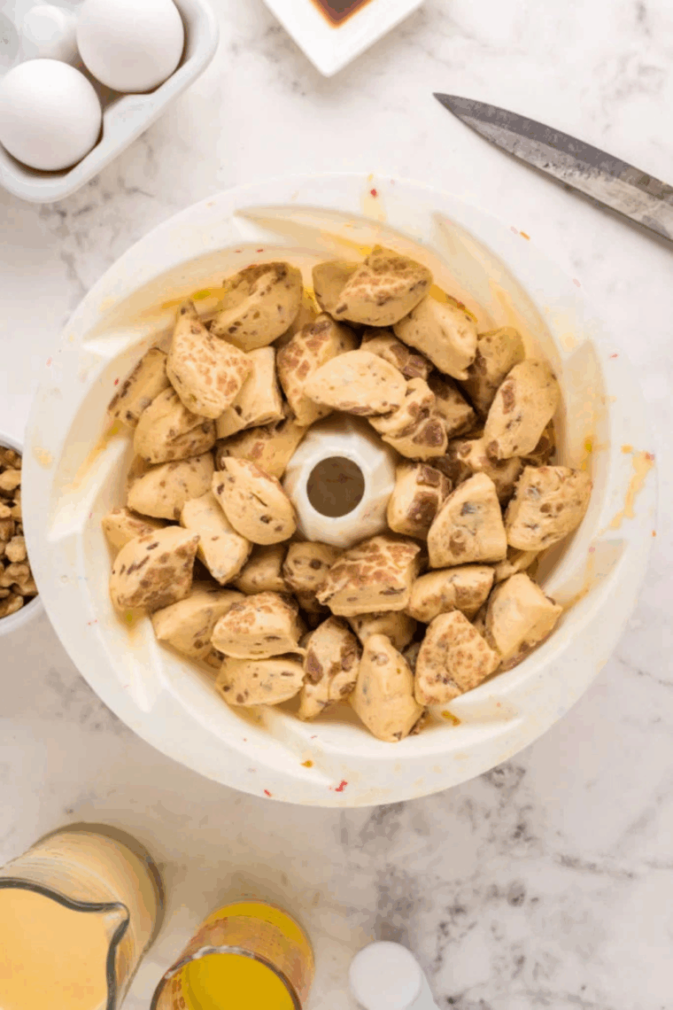 Bundt pan sprayed with cooking oil filled with diced cinnamon roll pieces