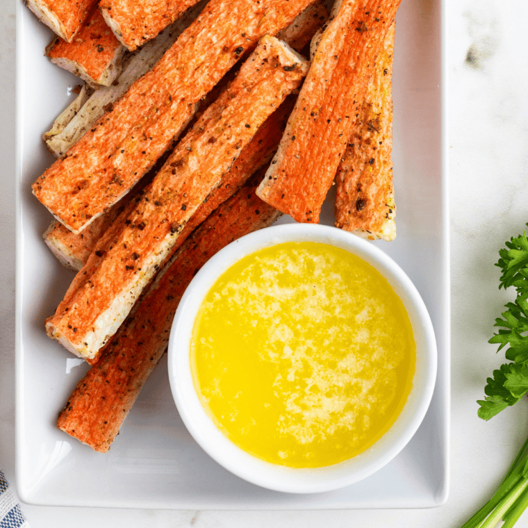 Homemade air fryer crab bites with crispy edges and melted garlic butter dip.
