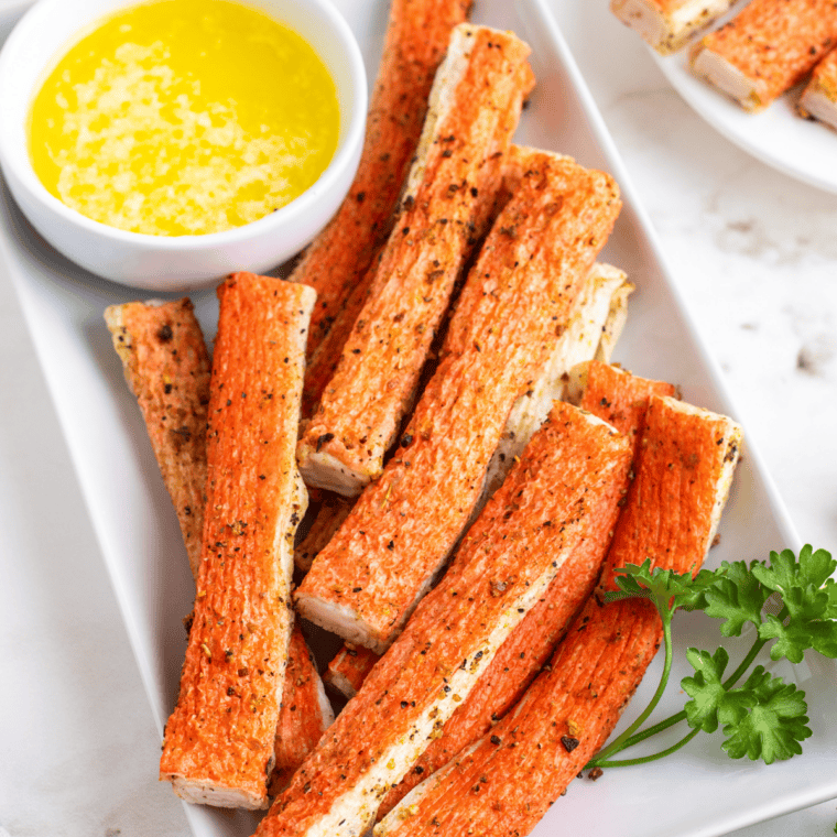 Golden brown imitation crab bites cooking in an air fryer basket until crispy.