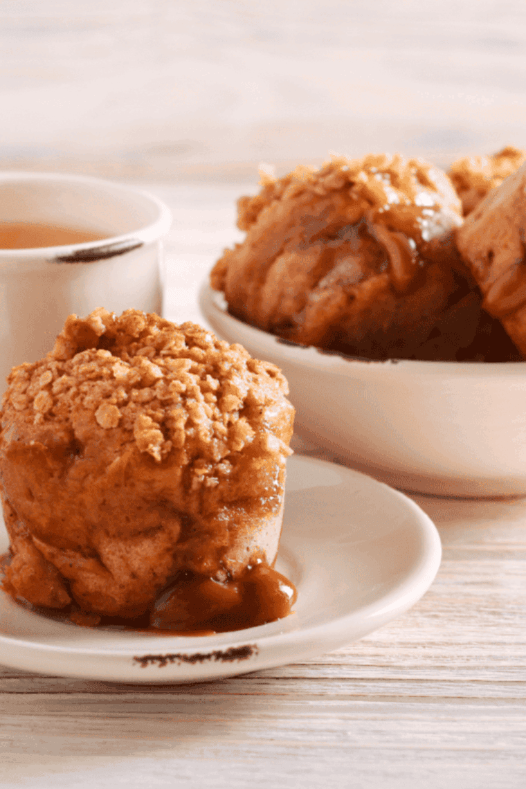 Golden air fryer caramel apple muffins with tender apple pieces and caramel drizzle, freshly baked and ready to enjoy.