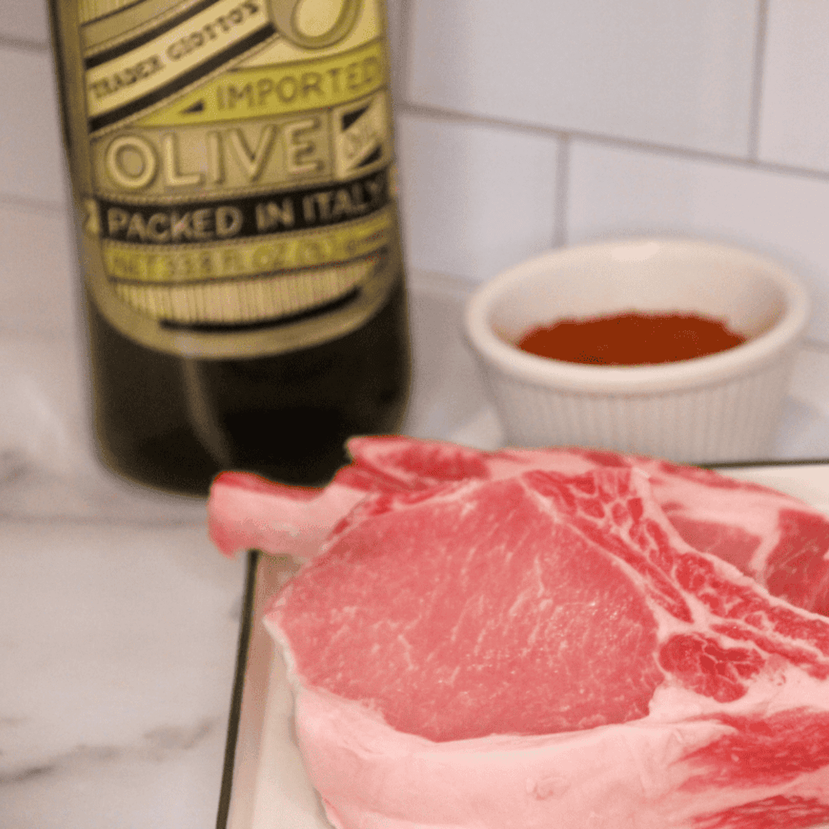 Ingredients needed for Air Fryer Chile Lime Pork Chop on kitchen table.